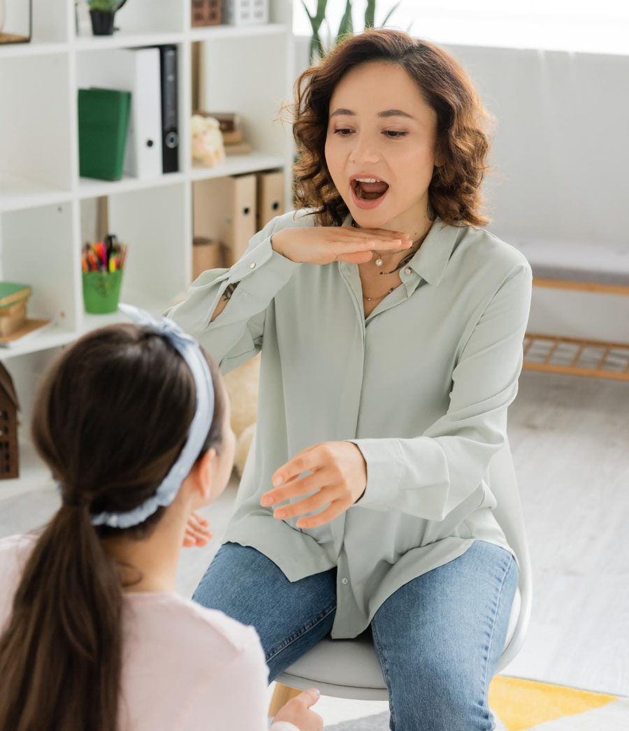 A speech therapist practicing sounds with a child